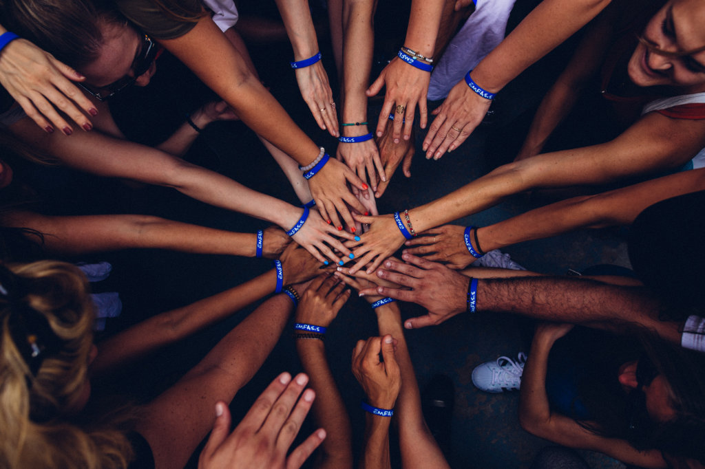 A group of people huddling.