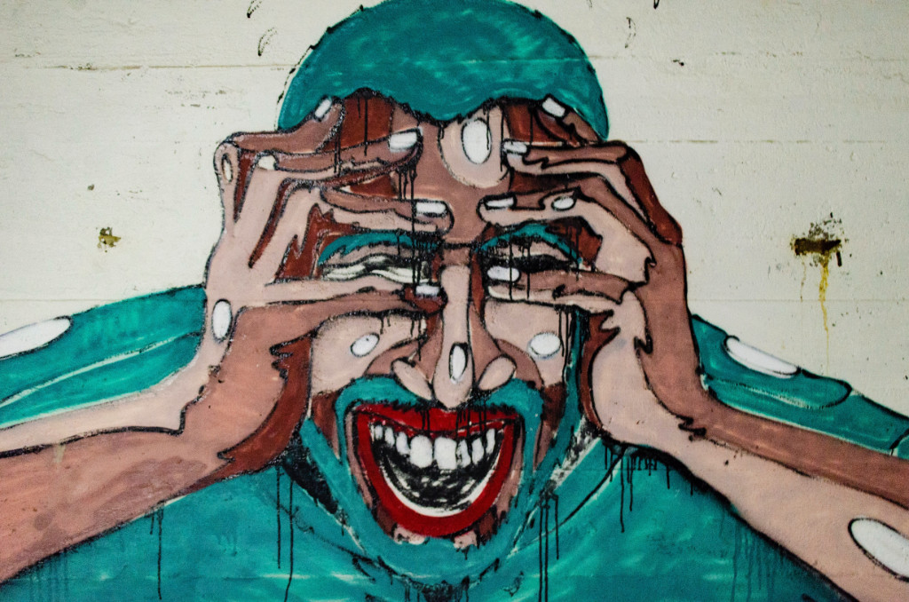 An abstract painting of a man holding his eyes and screaming.