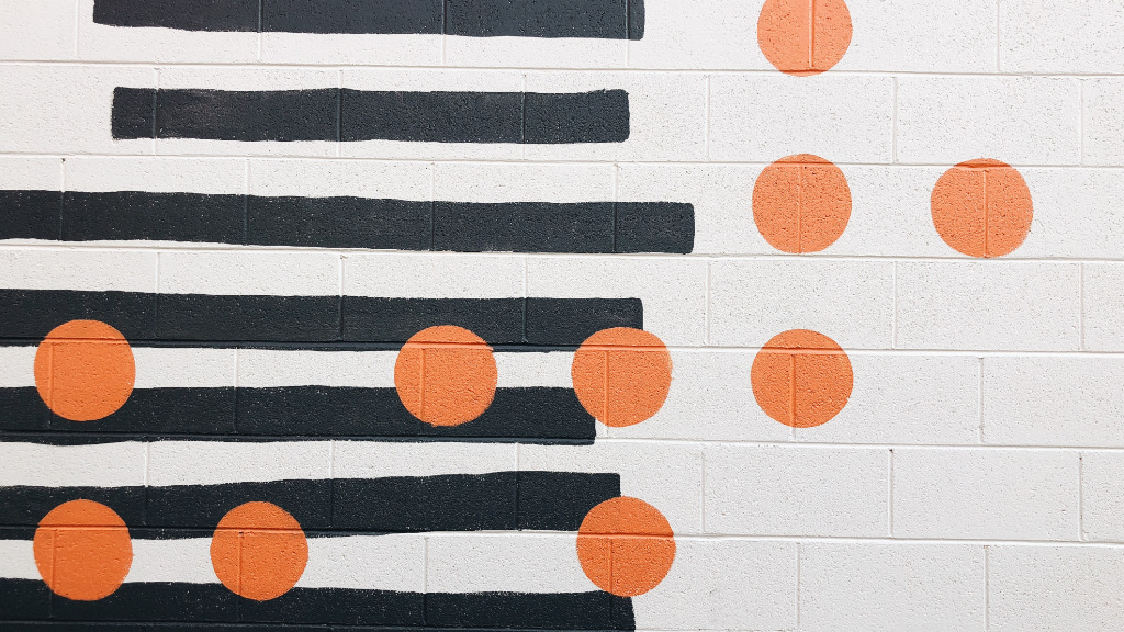 A wall with a random pattern of stripes and dots.