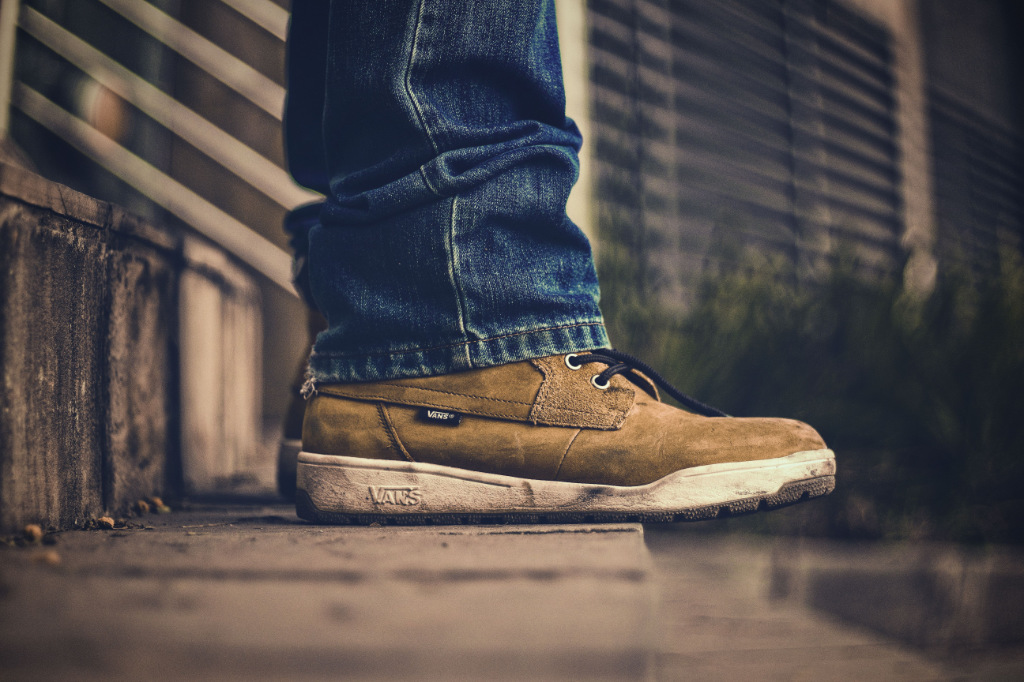 Legs of a person standing on the edge of a staircase.