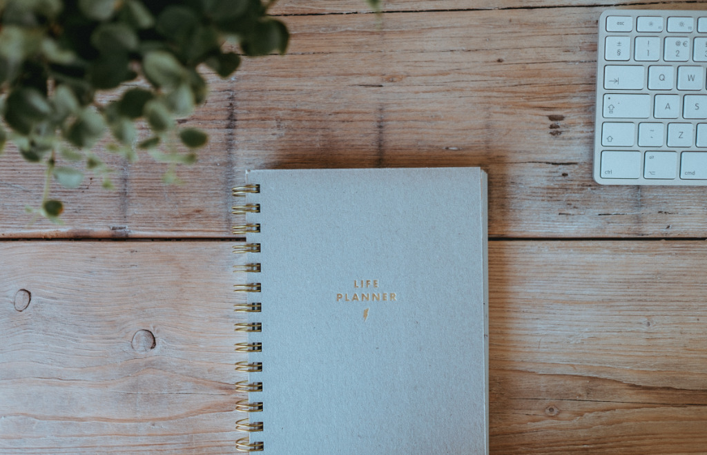 Gray notebook on a desk labeled "Life Planner".